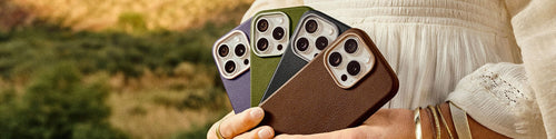 Woman holding a variety of colorful OtterBox Symmetry Series Cactus Leather iPhone cases for iPhone 16 Pro on a desert background