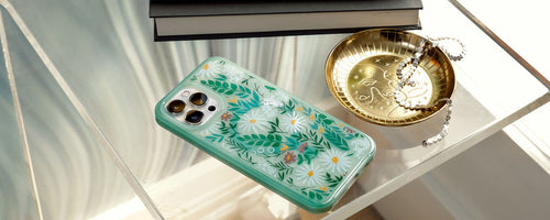 Green floral design OtterBox iPhone case on glass table