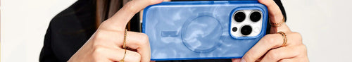 Woman holding stylish blue and white swirled OtterBox Figura Series Artist Collection for iPhone 15 Pro Max