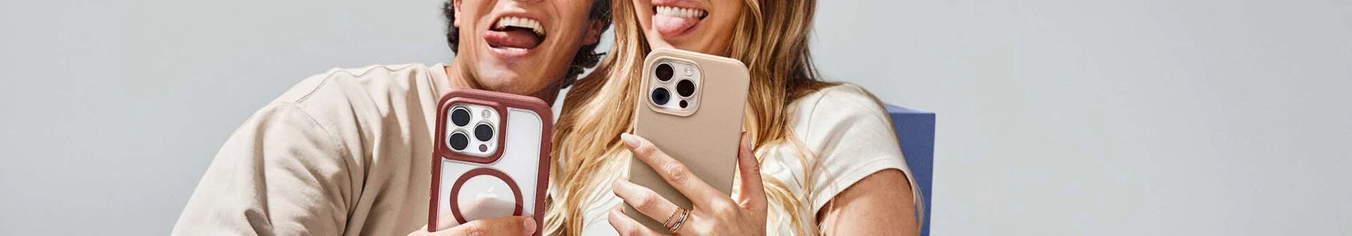 Man and woman taking selfies on iPhone 16 Pro in colorful protective OtterBox iPhone cases