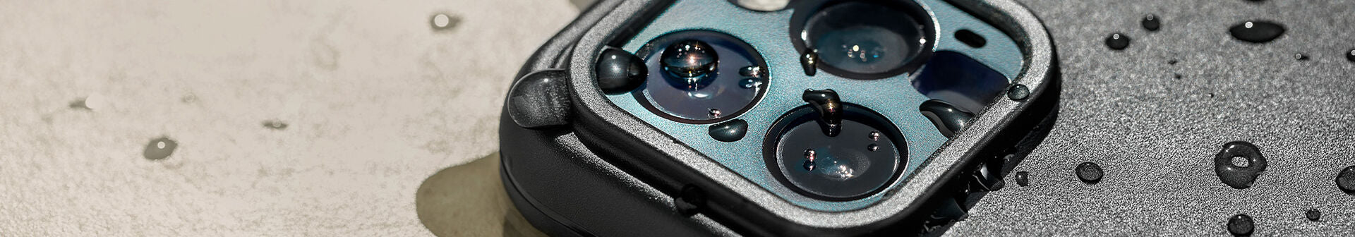 Black OtterBox Fre Series waterproof iPhone case with water droplets on it