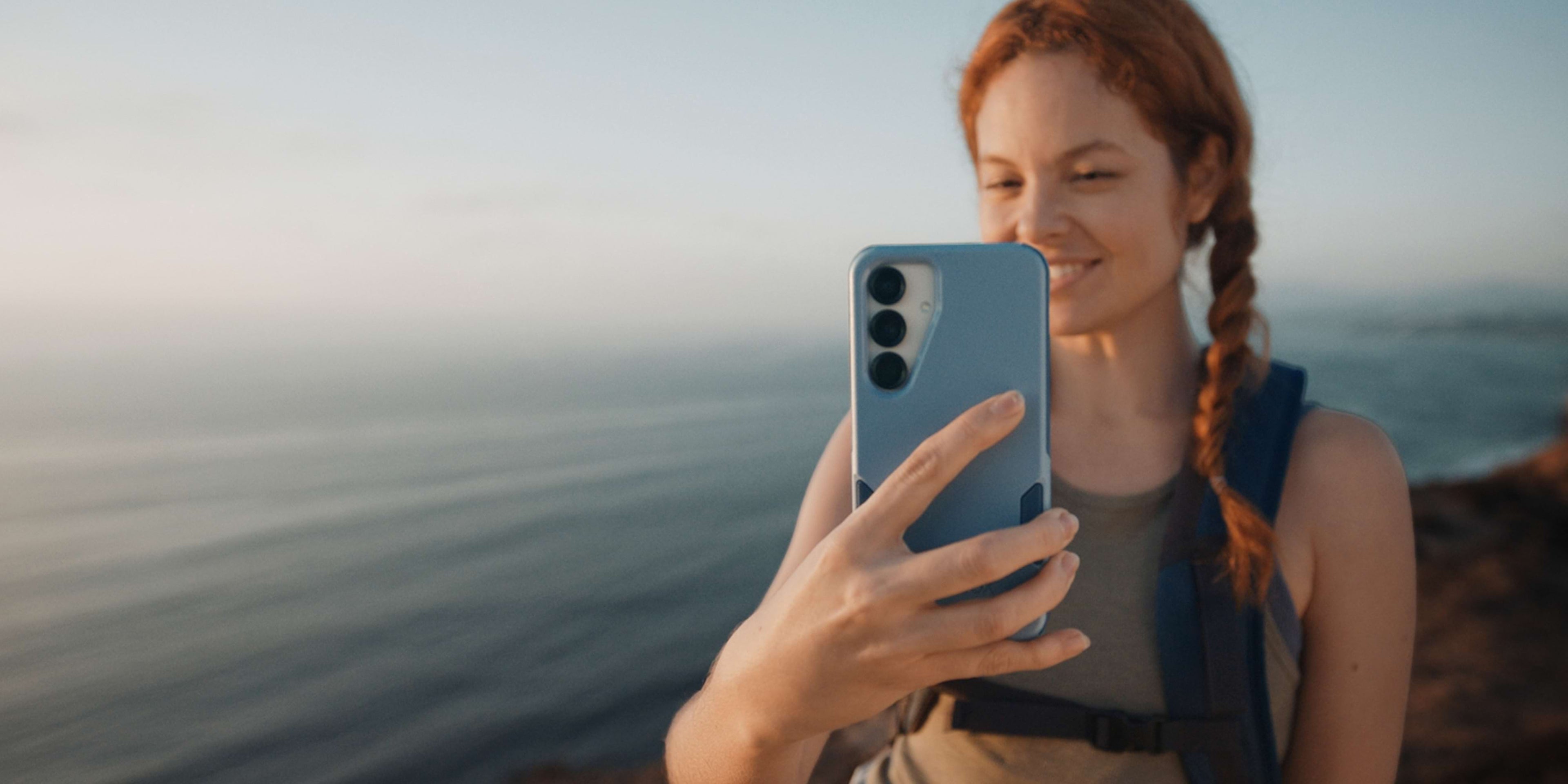woman holding blue otterbox commuter series phone case for samsung galaxy