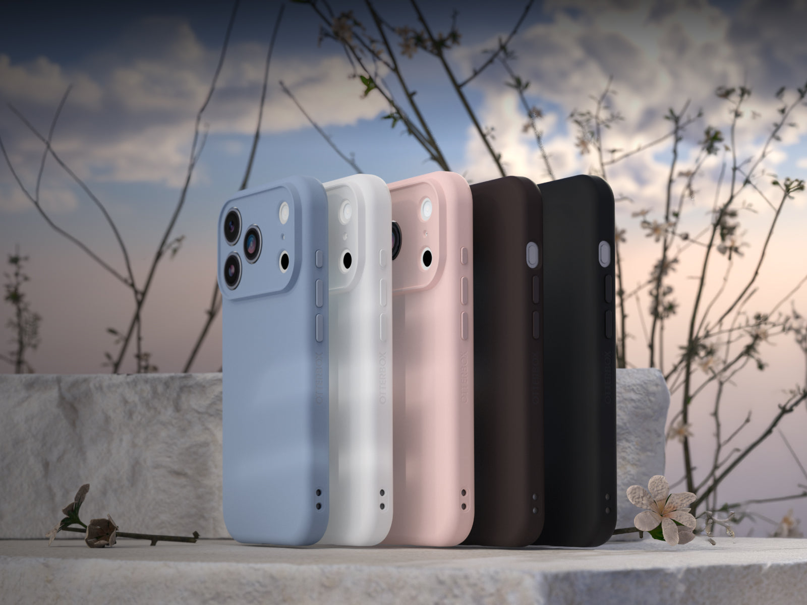 Four iPhones in different colors on a marble surface with a natural background