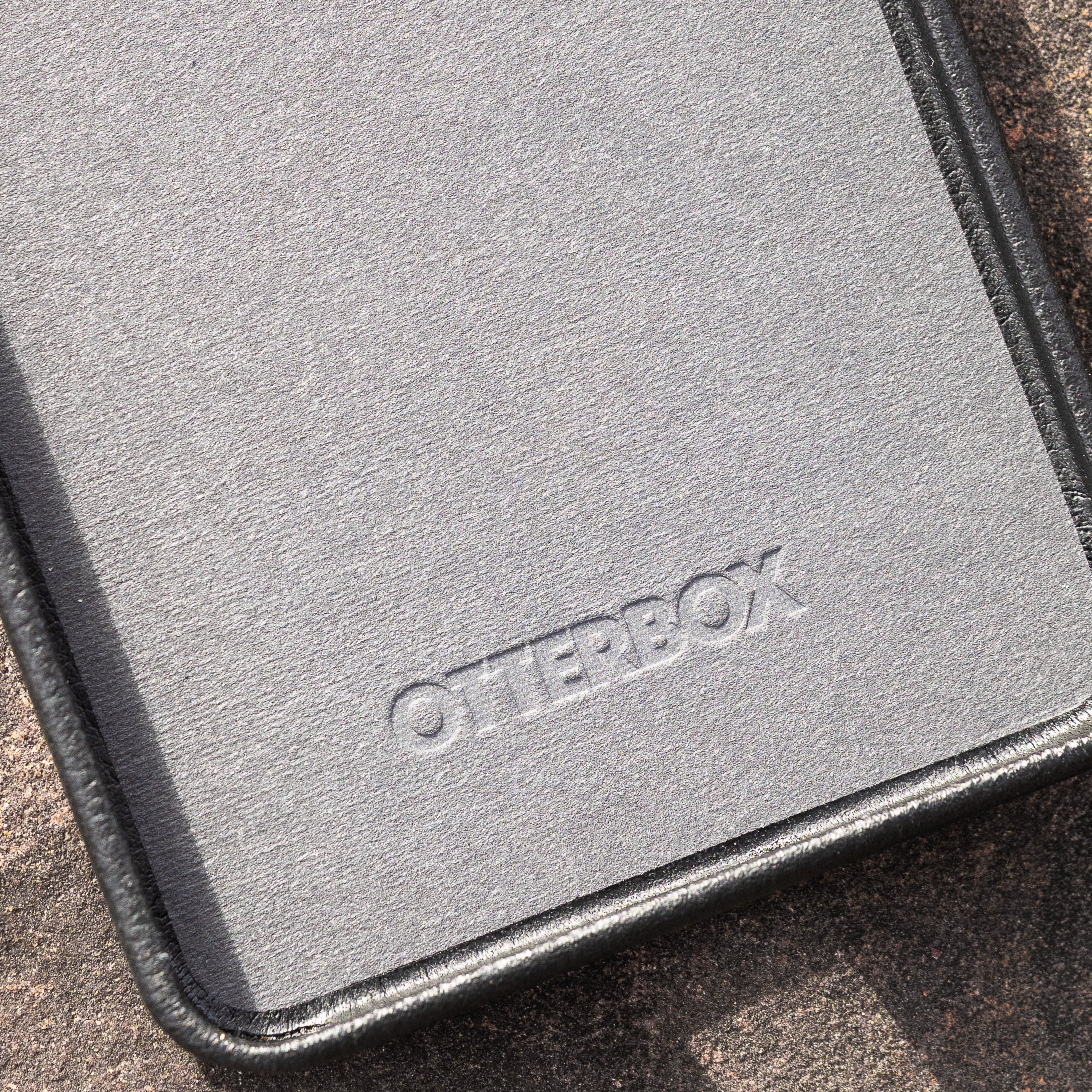 Close-up of the inside of OtterBox faux leather case on a textured surface