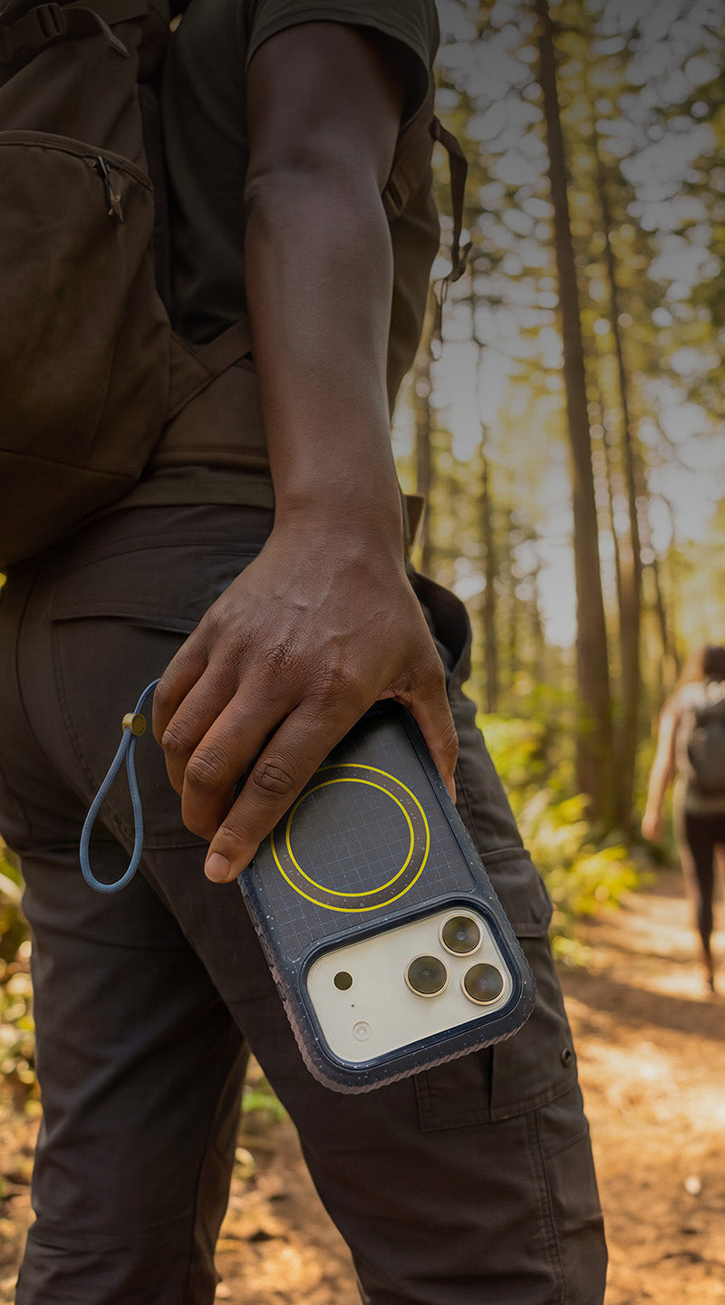 Person holding a blue sole series otterbox case in an outdoor hikinh background