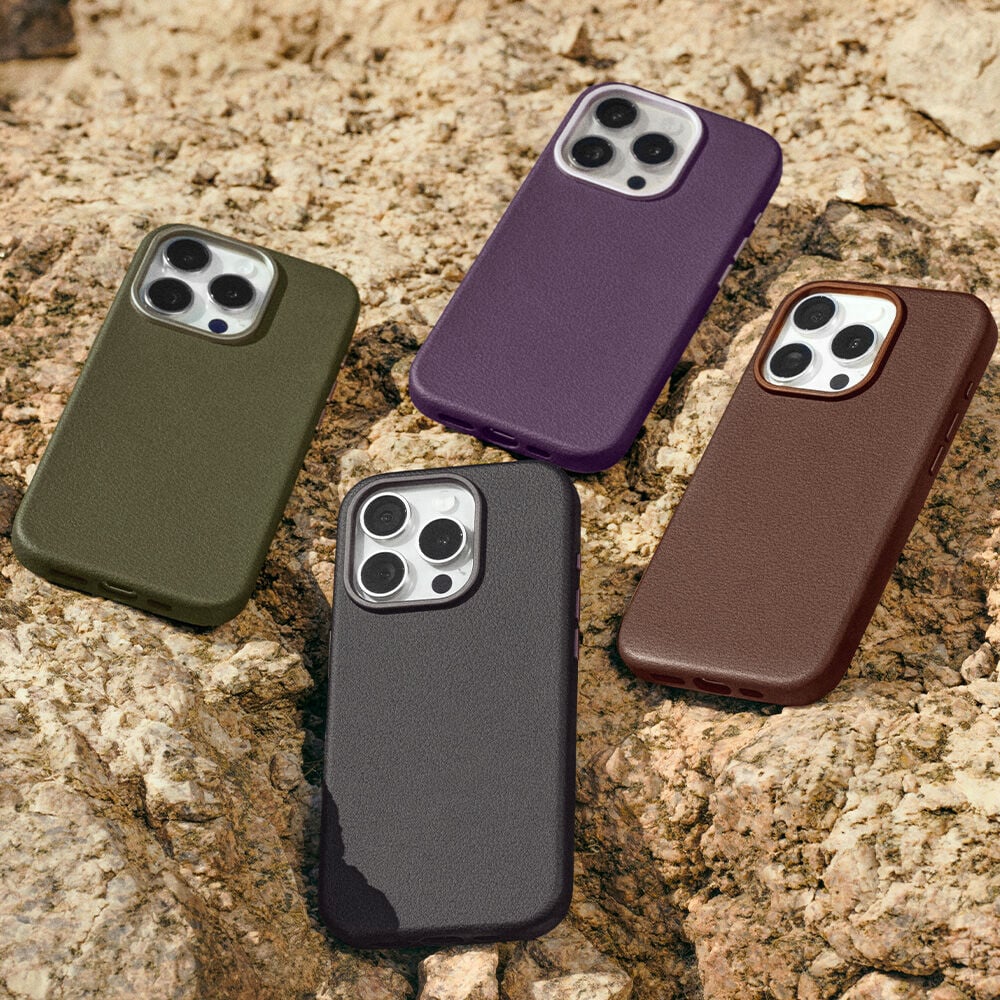 Four cactus leather phone cases in green, purple, black, and brown on a textured stone surface