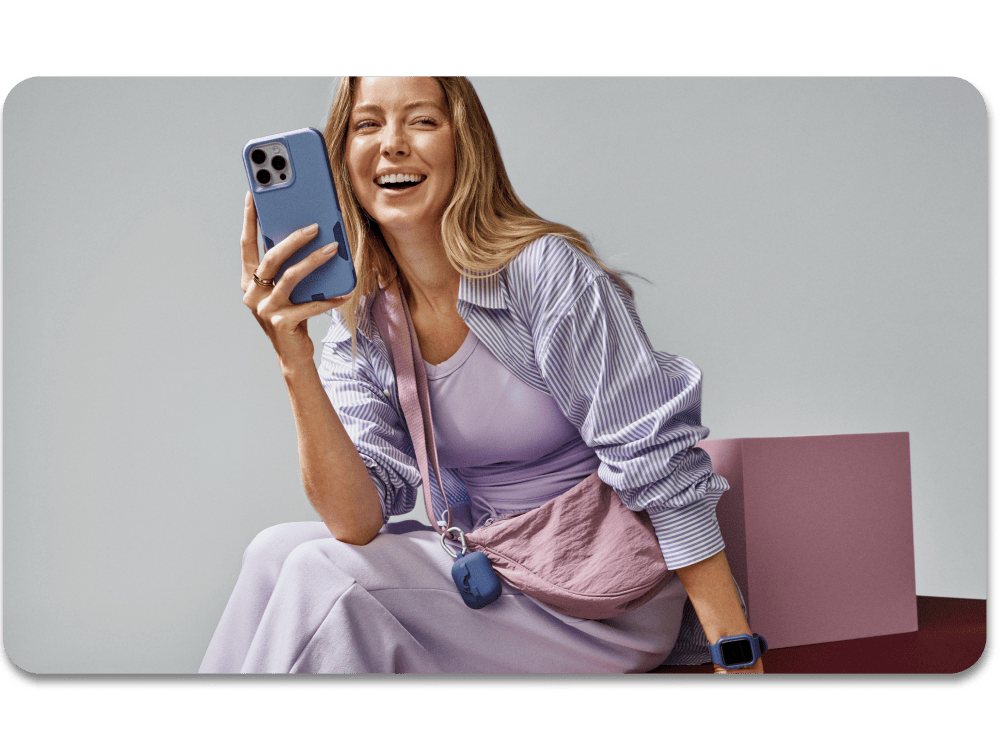 Woman holding a phone with a gray background