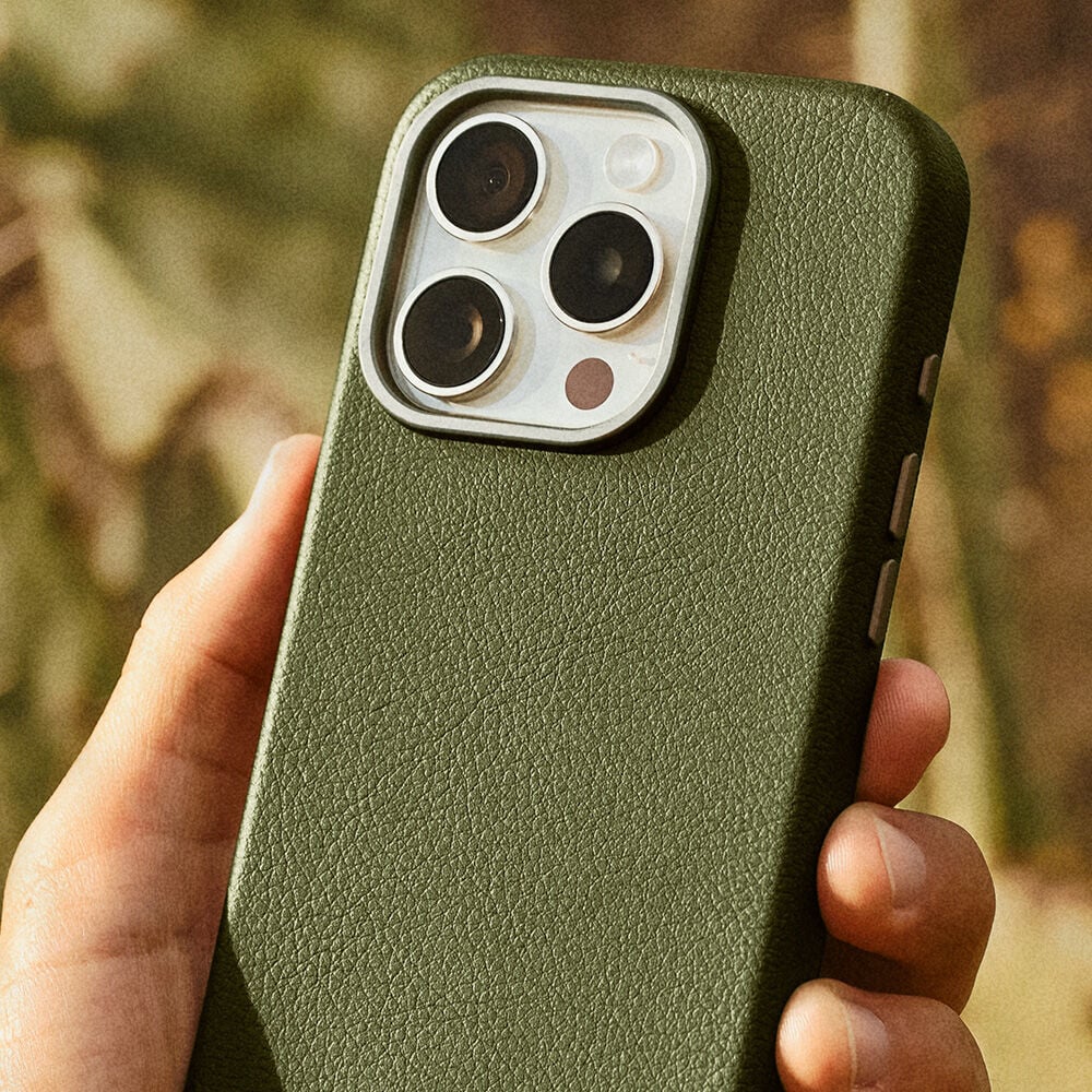 Green cactus leather phone case held by a hand with a blurred natural background