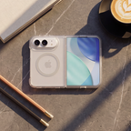 OtterBox Lumen Series case on iPhone duo smartphone displayed on a desk alongside a notebook, pencils, and a cup of coffee, highlighting its slim, transparent design.