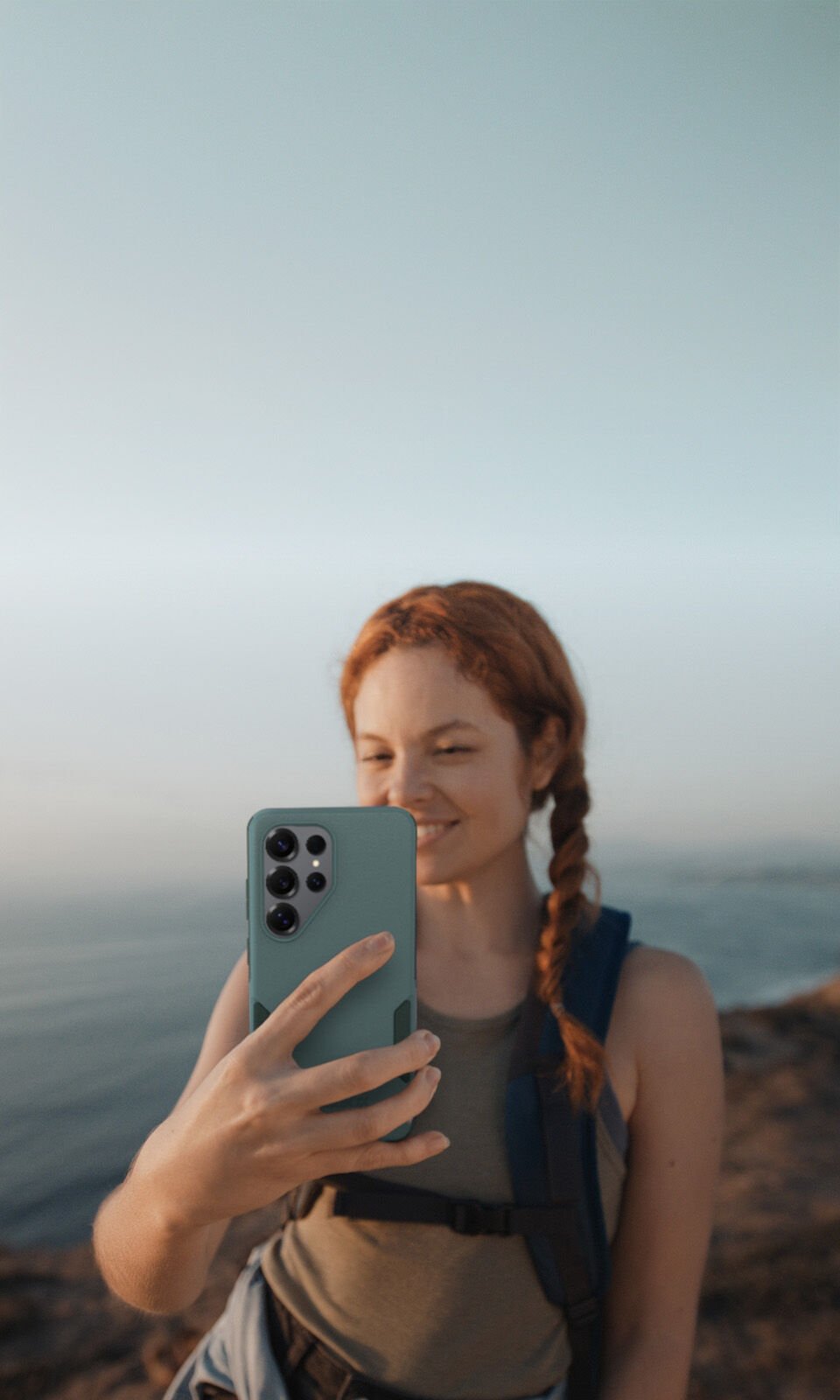 Woman taking a selfie on a beach with a clear sky