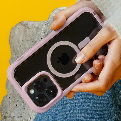 Person holding a phone with a pink case against a yellow background