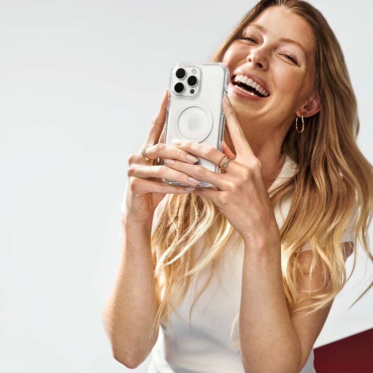 woman holding clear iphone case while smiling