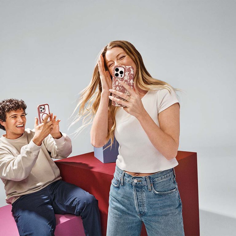 Man taking picture of woman with iPhone 16 in a trendy case | OtterBox