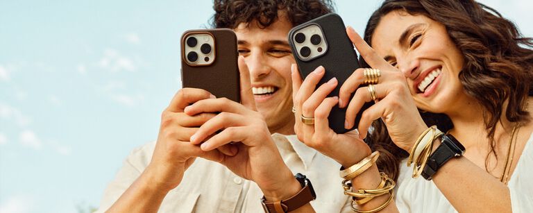 cactus leather iPhone cases and Apple watches leaning against cacti