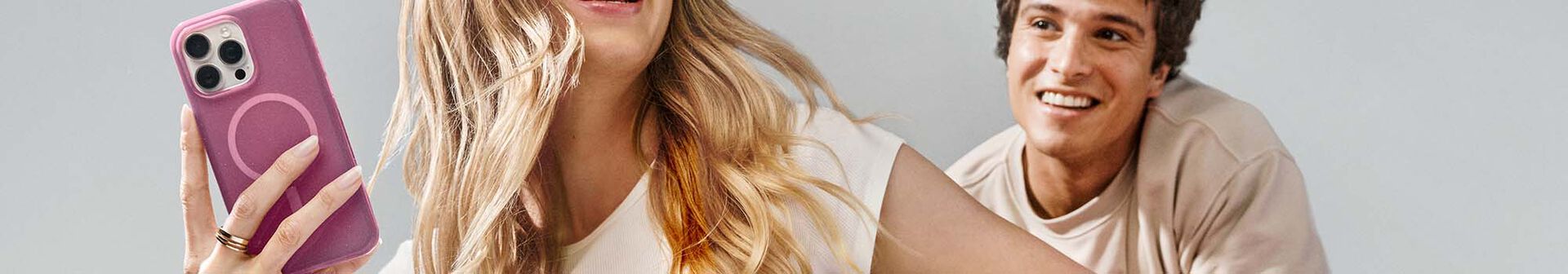 Woman and man smiling with trendy iPhone 16 cases | OtterBox