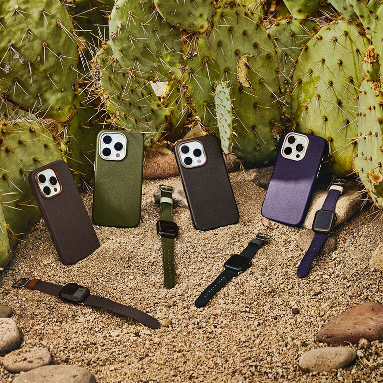 cactus leather iPhone cases and Apple watches leaning against cacti