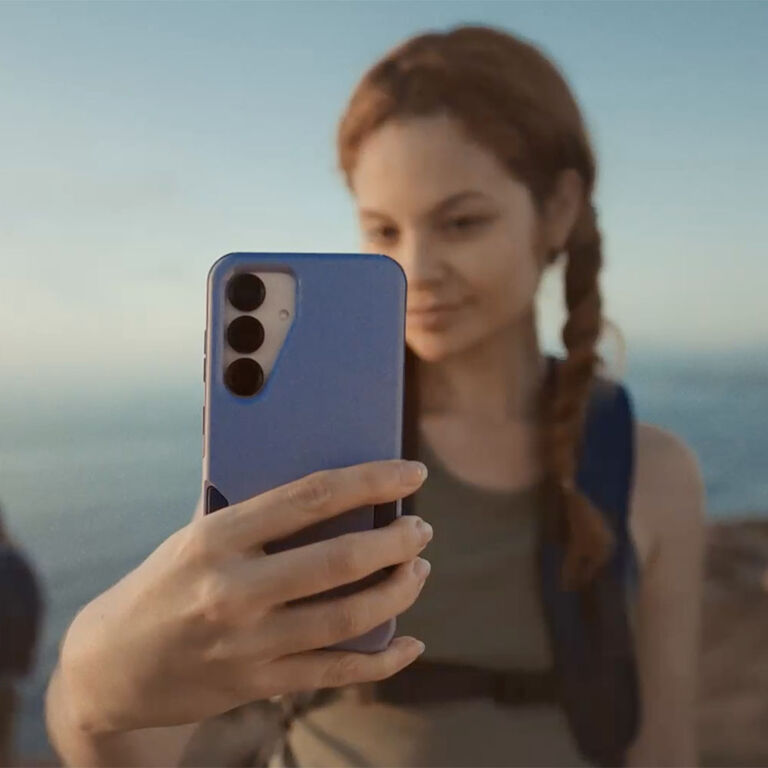 Woman taking a selfie with purple Galaxy phone case | OtterBox