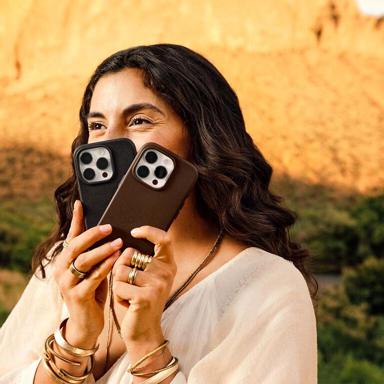 Girl holding cactus leather iPhone cases in the desert