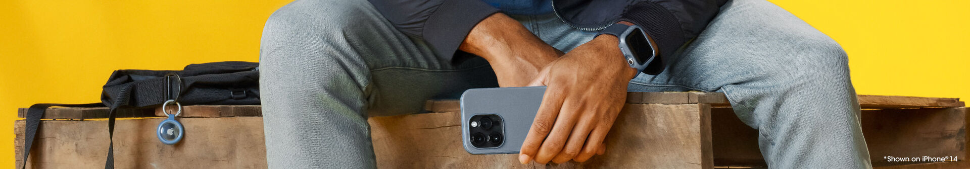 Woman holding an iPhone with a blue phone case matching the blue watch band on her Apple Watch she is wearing. Also shows a matching blue case holding an Apple AirTag.